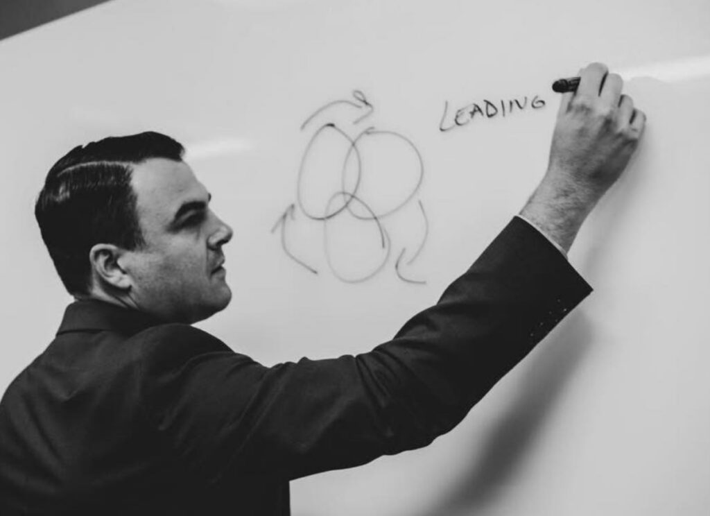 Brian Bennett writing on a whiteboard